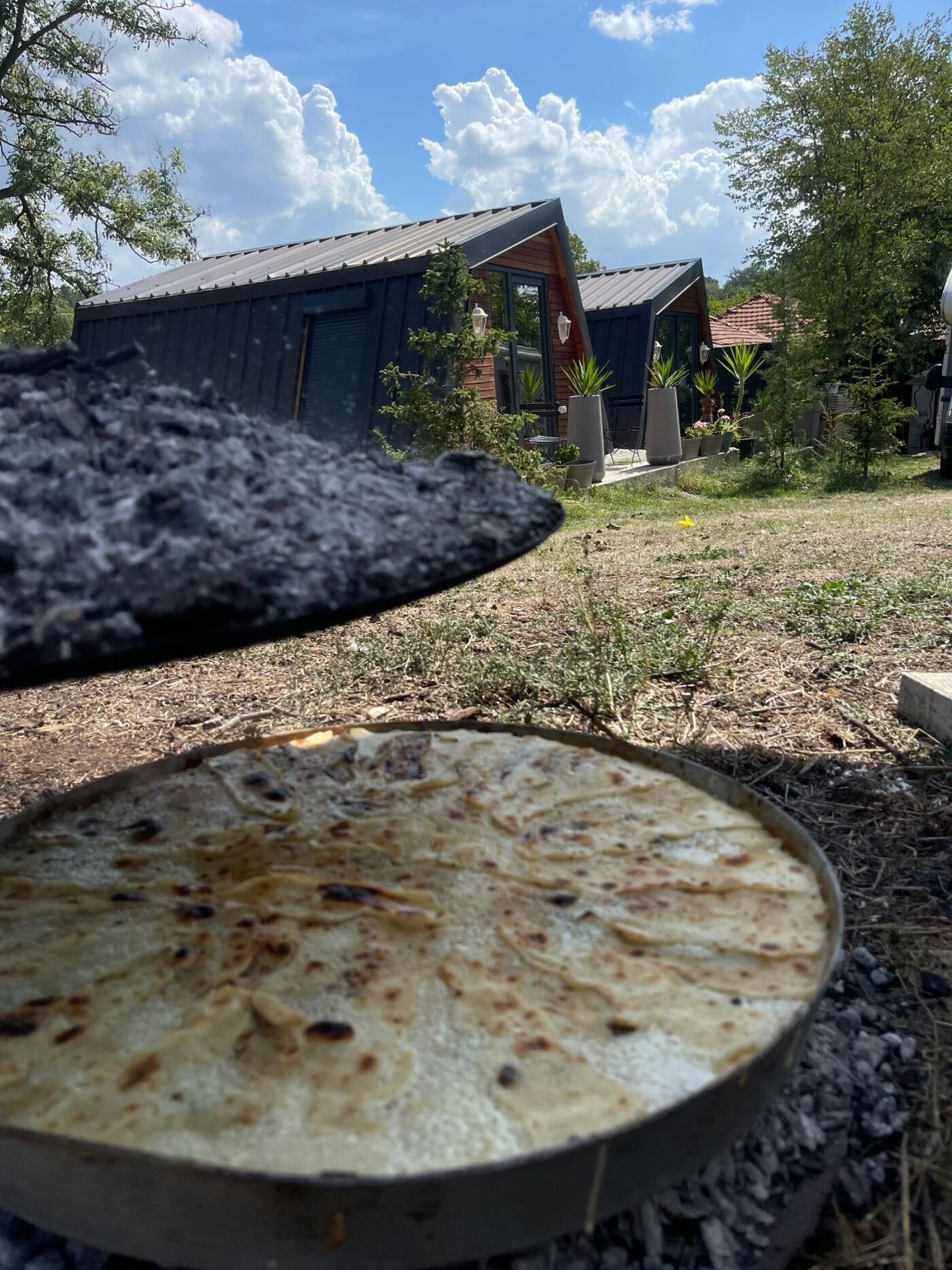 Homemade Kosovan flatbread cooking over an open fire