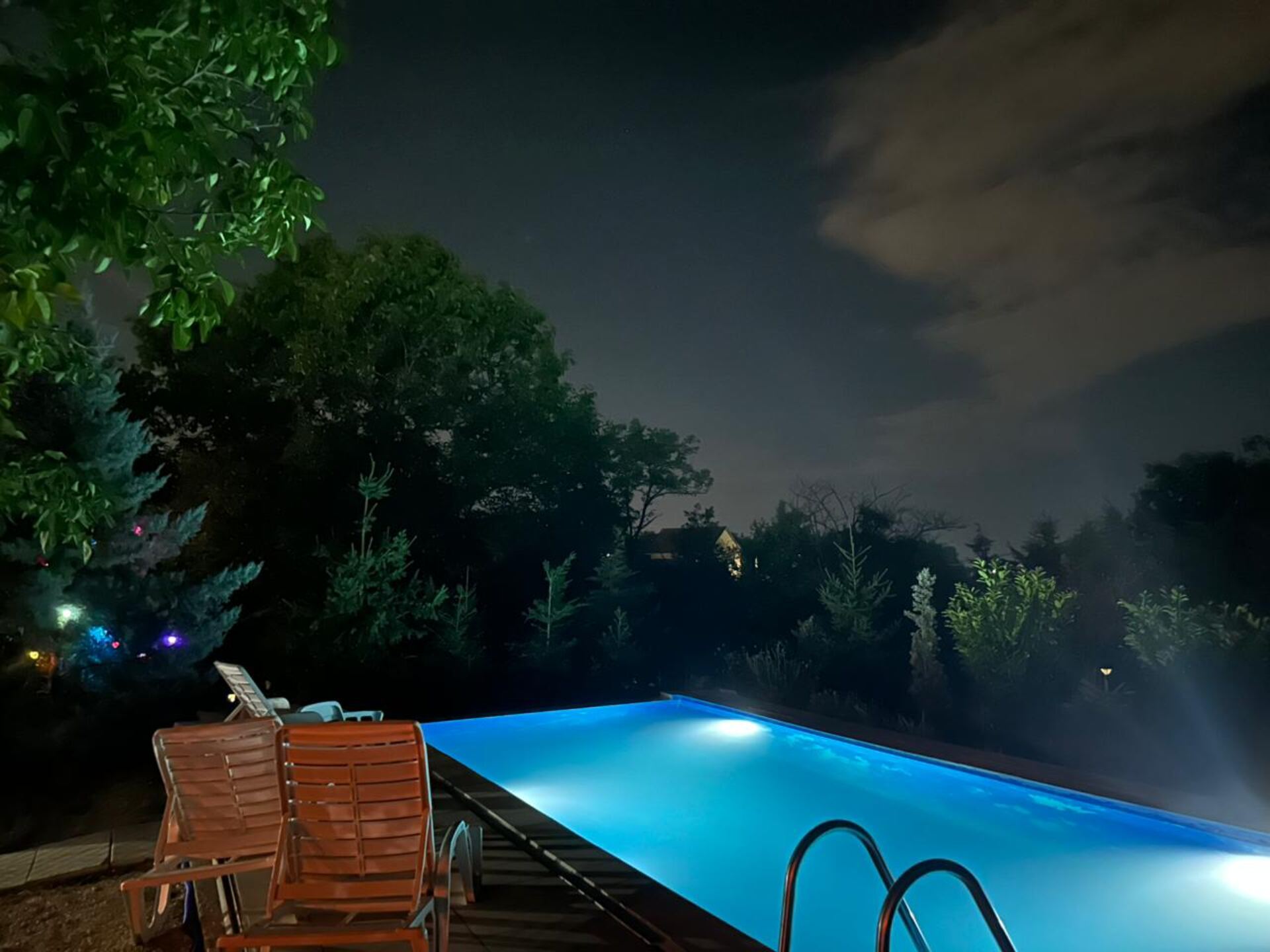 Campground pool lit up blue at night, Teddy Camp Kosovo
